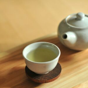 white ceramic teacup on brown wooden table