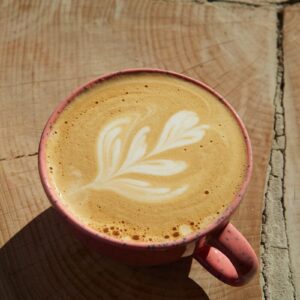 A cup of coffee sitting on top of a wooden table