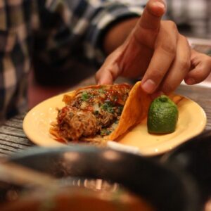 a person holding a plate of food