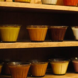 a shelf filled with lots of different colored bowls