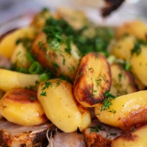 Roasted pork and potatoes with fresh dill garnish