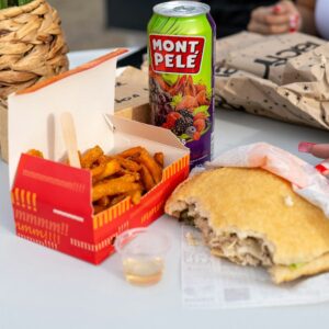 a table with a half eaten sandwich and a can of donut pelle